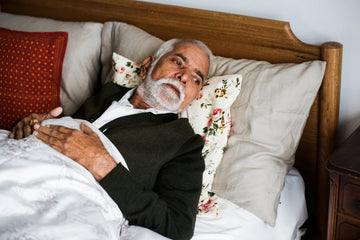 Elderly bedridden man resting in bed, illustrating complications associated with prolonged bed rest
